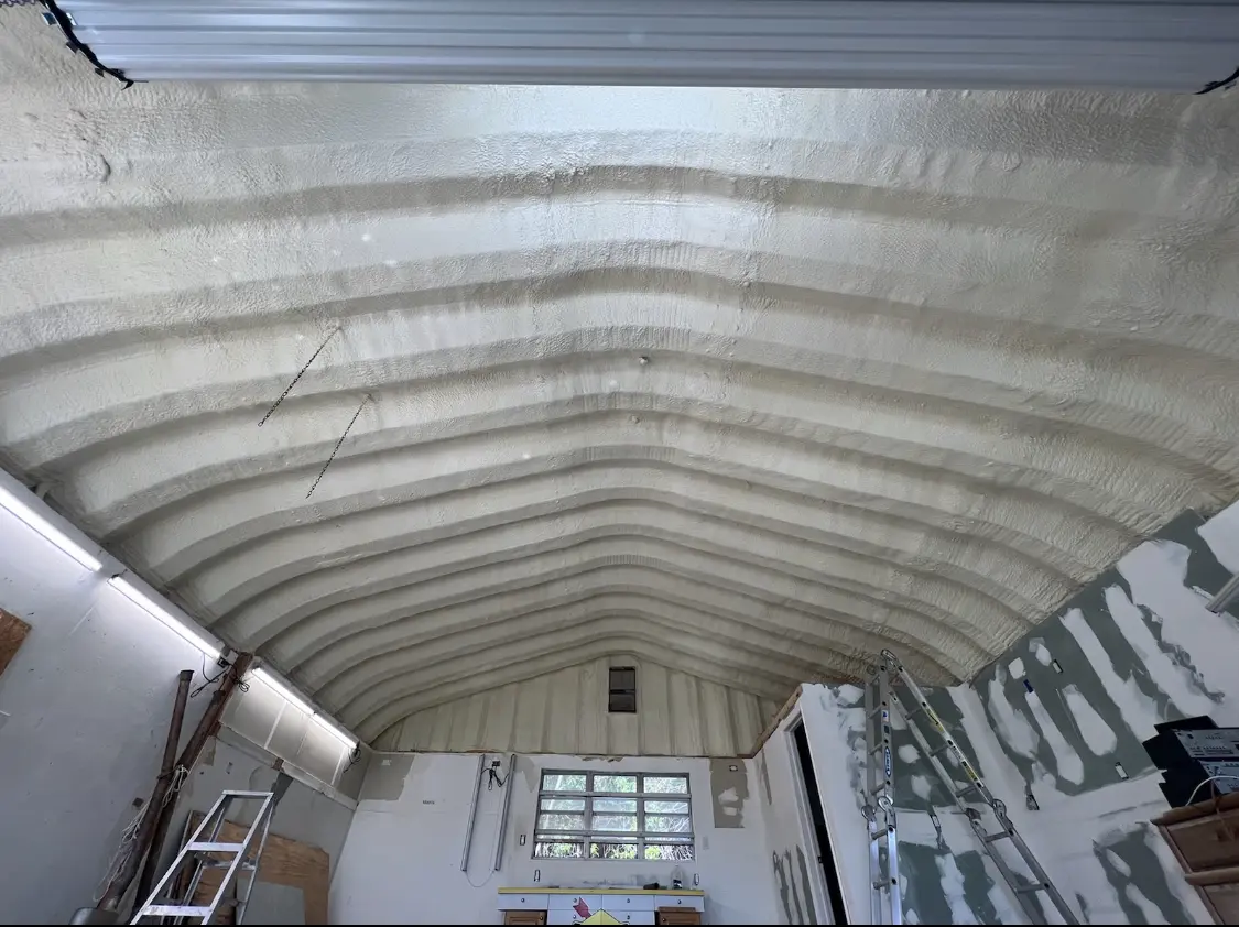 Spray polyurethane foam applied to the underside of a metal roof deck in Cambridge